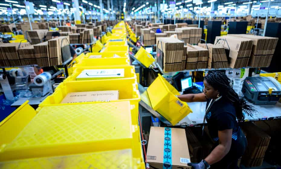 A woman works at a packing station at the 855,000-square-foot Amazon fulfillment center in Staten Island, New York.