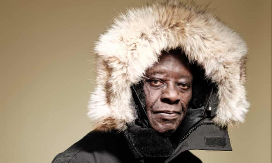 Head shot of Tété-Michel Kpomassie wearing a fur-lined hood