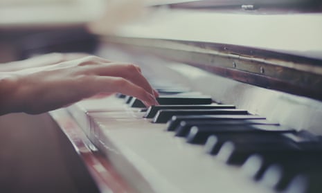 A woman's hands playing a piano