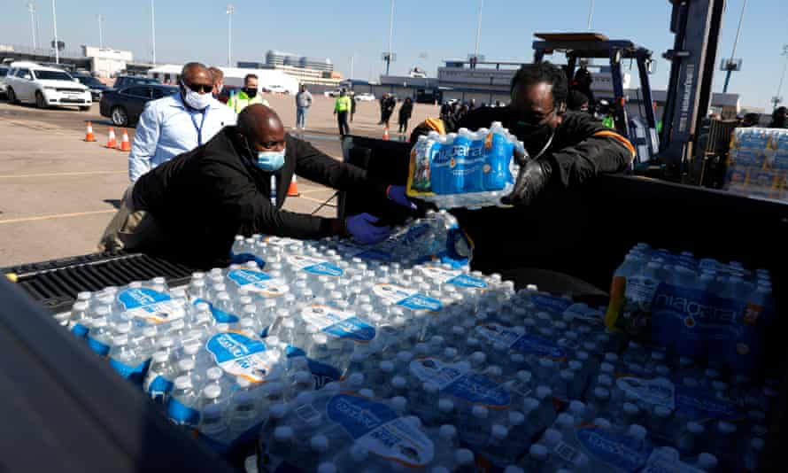 Volunteers distribute water in Houston, Texas, after power outages and a shortage of drinking water.