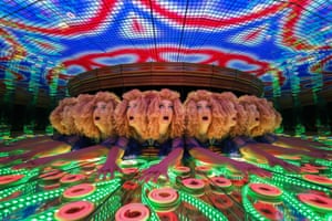 Person with orange curls has their image replicated 12 times inside a kaleidoscopic funhouse mirror