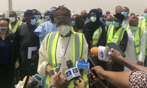 Nigeria's Minister of Information and Culture Lai Mohammed (C) gives statements to the media at the delivery ceremony of the first AronaZenec / Oxford coronavirus vaccine badge, provided by Covax.