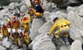 Rescuers climb over huge boulders
