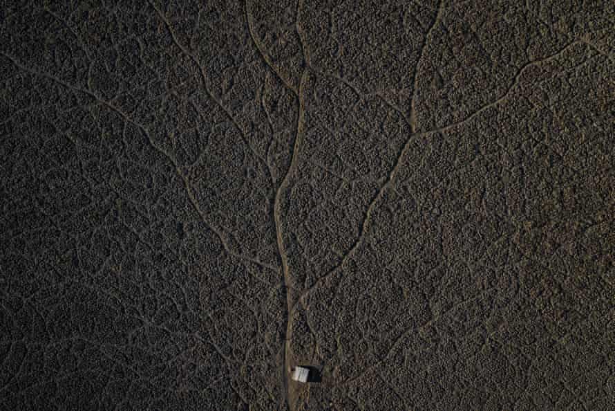In this aerial photo, a pier sits on the dried lake bed of the Aculeo Lagoon in Paine, Chile, on December 2021.
