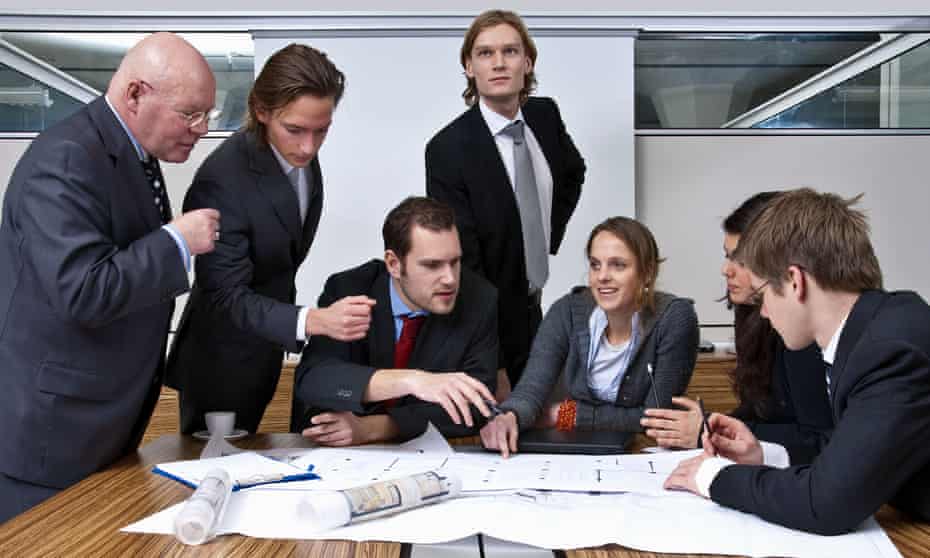 A company manager, and his team, discussing plans in a modern office