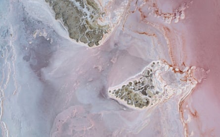 Pink coloured water at the edge of salt pan and land. Madigan Gulf, Lake Eyre North, South Australia, Australia March, 2022 Cropped.