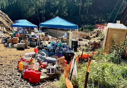 Supplies like water bottles and toilet paper in piles outside