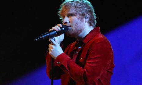 Ed Sheeran performs at a concert.