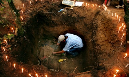 A forensic anthropologist works to exhume a body of a poor farmer killed by the Guatemalan army in 1982 during the country’s civil war, in Chucalibal, Quiché