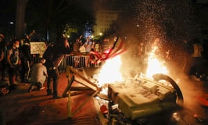 Demonstrators start a fire as they protest the death of George Floyd near the White House.