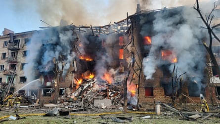 A destroyed and partially on fire apartment building
