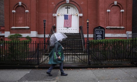 A man walks past a closed church in Brooklyn, New York