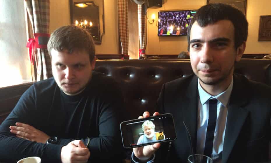 Alexei Stolyarov, left, and Vladimir Kuznetsov in Moscow show video of their prank on Ukrainian oligarch Ihor Kolomoisky.