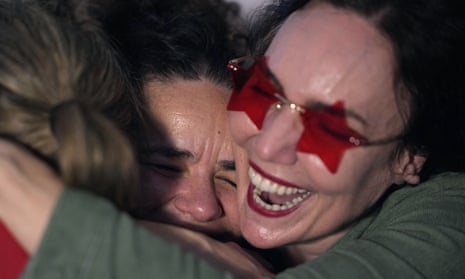Supporters of former Brazilian President-elect Luiz Inacio Lula da Silva hug each other as they learn he won Brazil's presidential election, while following the results at a Brazilian cultural association in Lisbon, Sunday evening, 30 October 2022.