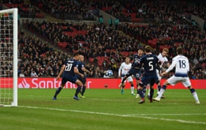 Harry Kane’s header deflects off two defenders.