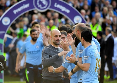 Guardiola leads out his players.