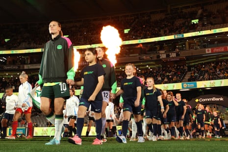 Emily van Egmond of Australia leads her players out onto the field.