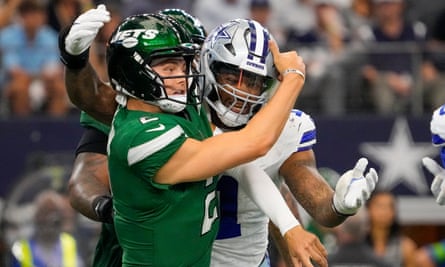 Zach Wilson gets off a pass under pressure from Micah Parsons