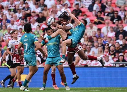 Wigan’s Junior Nsemba catches the ball above several Hull KR defenders