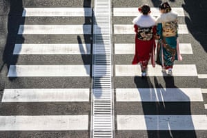 Two women cross a street in Yokohama