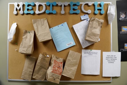 Paper bags containing N95 masks hang on a bulletin board waiting to be used again by staff inside a portion of Scotland County Hospital where Covid-19 patients have been isolated.