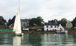 View of Chez Charlemagne from opposite river bank, yacht on water, Ile aux Moines, France.
