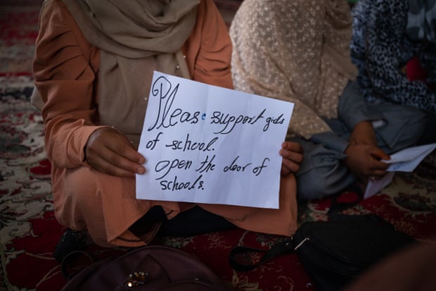 A student holds a sign she has prepared for the Guardian’s visit to a secret girls’ school