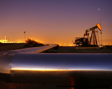 An oil rig and oil pipeline at sunset in California.