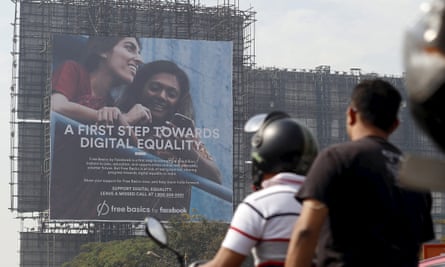 Motorists ride past a billboard displaying Facebook’s Free Basics initiative in Mumbai, India, December 30, 2015.