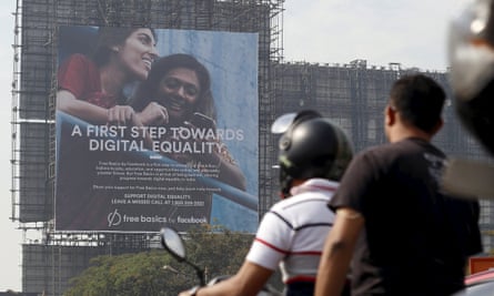 Motorists ride past a billboard displaying Facebook’s Free Basics initiative in Mumbai, India, 2015.
