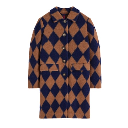 A long camel and navy argyle coat on a white background