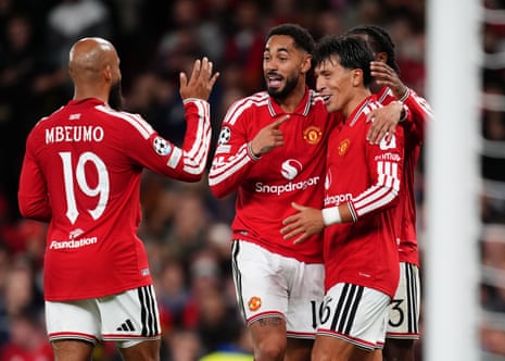 Matheus Cunha points to Lisandro Martinez as they celebrate