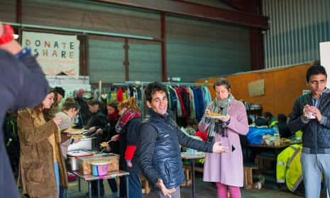 Refugees and volunteers at a warehouse run by L’Auberge des Migrants.