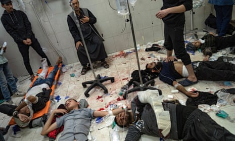 Palestinians lie on the hospital floor as they wait to be treated.