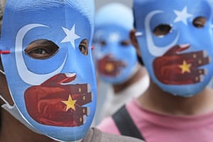 Student activists wear masks with the colours of the Kökbayraq, a flag unofficially used to represent the Xinjiang region of China and the historic region of east Turkestan, outside the Chinese embassy in Jakarta, Indonesia.
