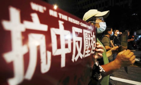 Protesters hold signs reading 'anti-Chinese oppression' outside parliament in Taipei, Taiwan, in 2021