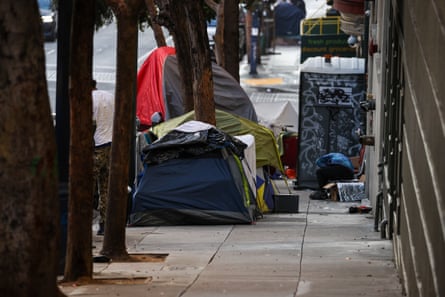 Tents and a portable bathroom line a street in San Francisco.