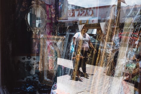 a woman reflected in a shop window