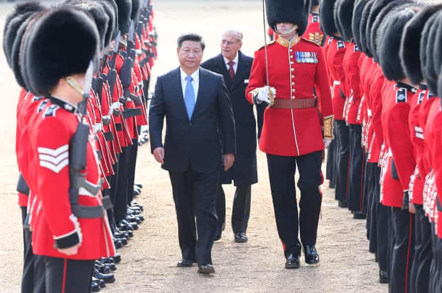 Chinese President Xi Jinping, accompanied by Prince Philip, inspects the guard of honour during a traditional ceremonial welcome held by British Queen Elizabeth II at the Horse Guards Parade.