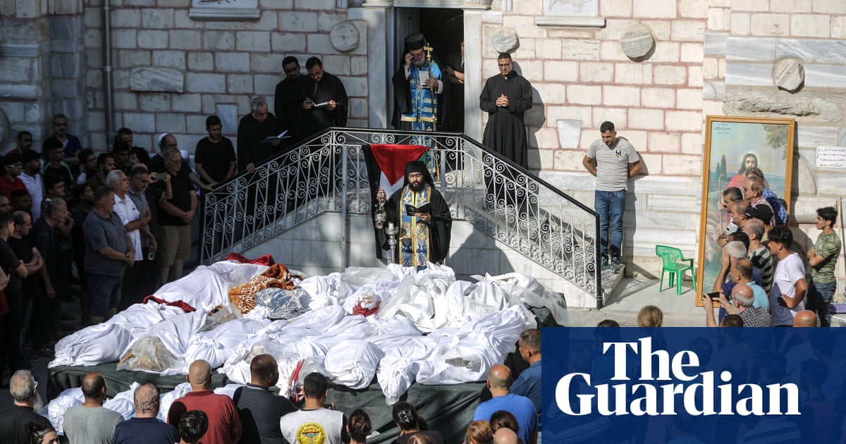 Destruction chased them': funeral held for those killed in Gaza church airstrike | Israel-Gaza war | The Guardian