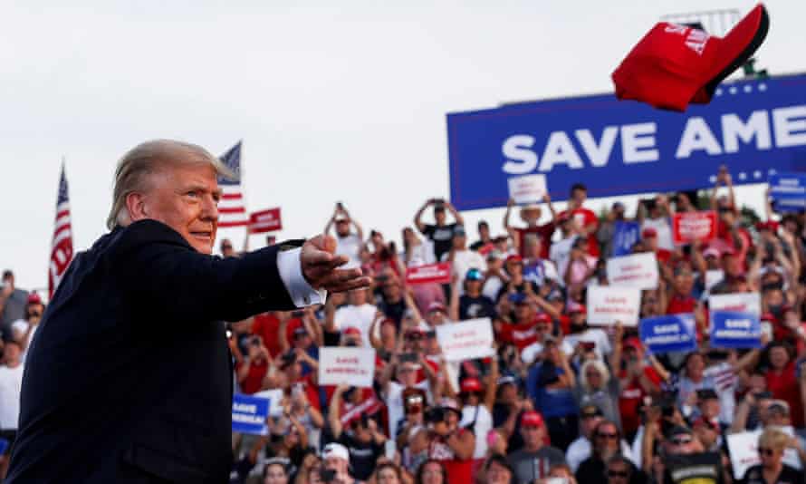 Donald Trump tosses a hat into the air at his first post-presidency rally in Wellington, Ohio