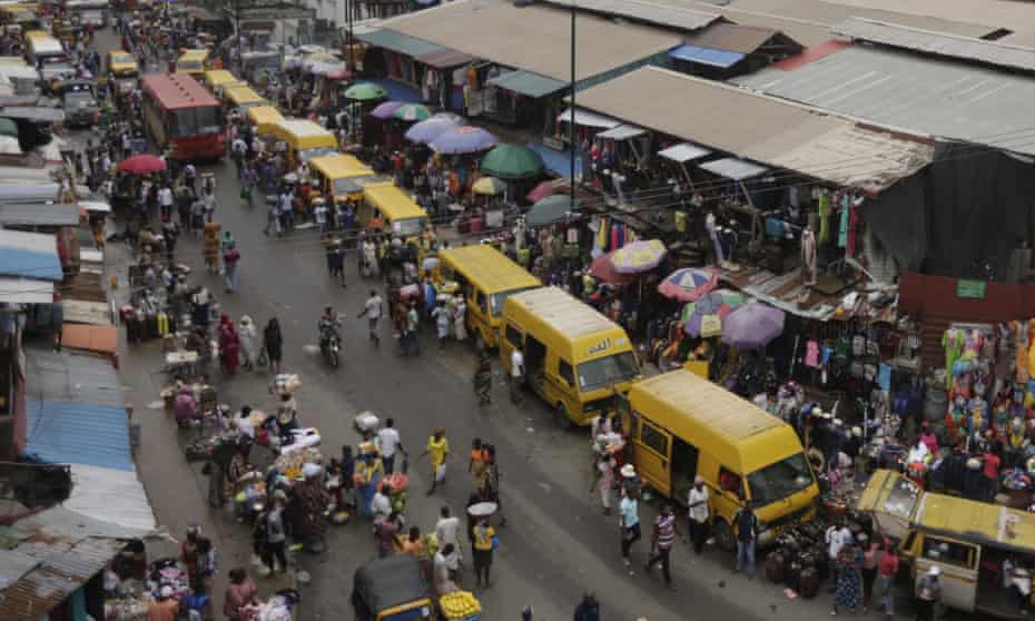 People shopping at a market in Lagos, Nigeria.