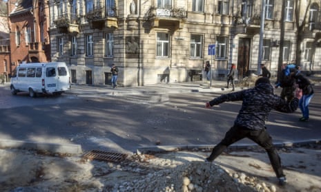 Members of far-right groups throw stones during a protest against the LGBT community in Lviv, Ukraine
