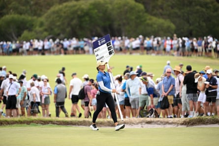 Australian golfer Steph Kryiacou carrying the scores for Adam Scott, Rory McIlroy and Min Woo Lee.