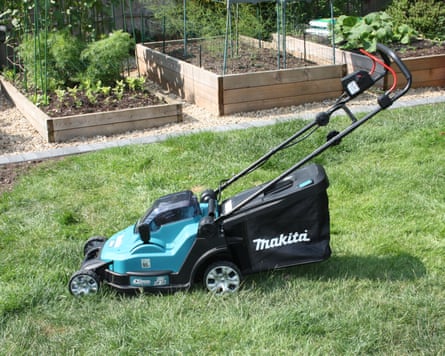 A Makita lawnmower on the grass of a garden