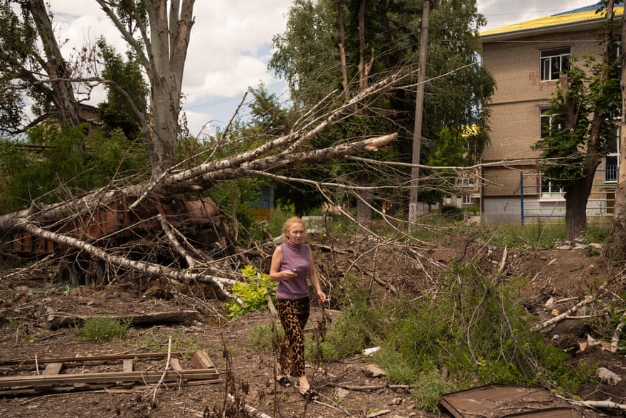 Svitlana walks by the crater left by a shell in Sloviansk on 13 July.