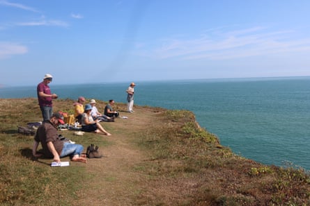 People sitting on a cliff top