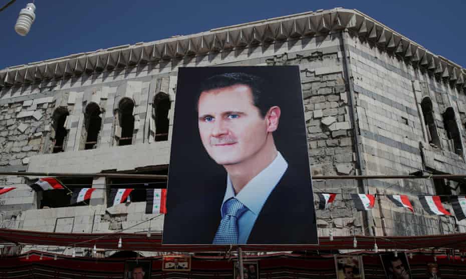 A banner depicting Syrian President Bashar al-Assad in Douma, outside Damascus, Syria, September 17, 2018. REUTERS/Marko Djurica/File Photo