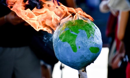 Protesters in Marseille set a model of Earth on fire during a demonstration where members of Extinction Rebellion were supported by gilets jaunes, in July.