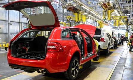 red holden station wagon at manufacturing plant